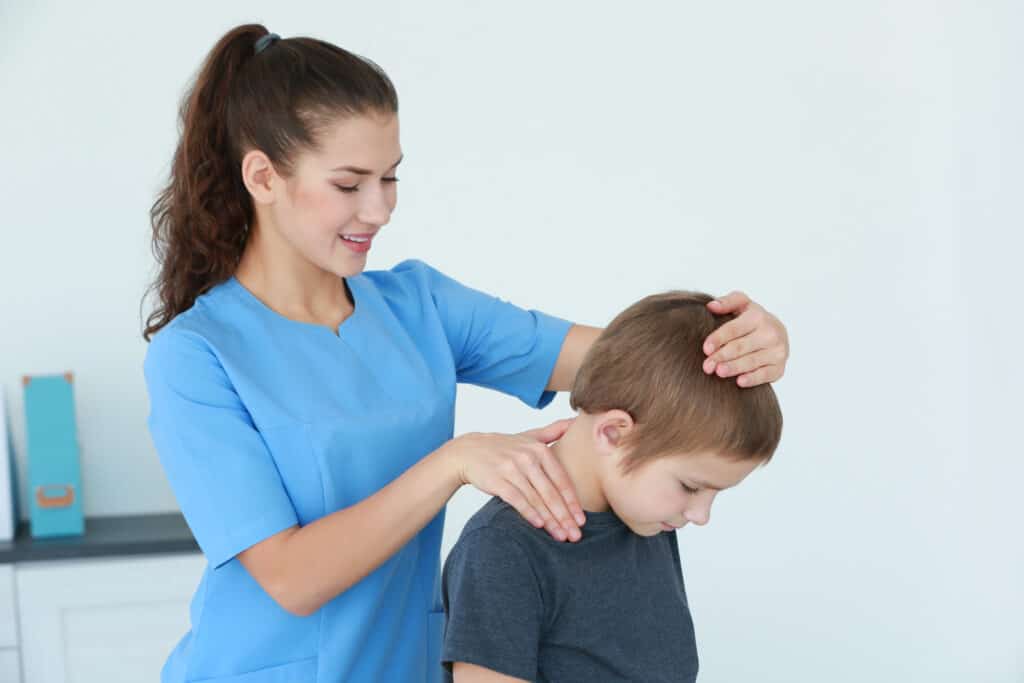 child with back pain seeing physical therapist
