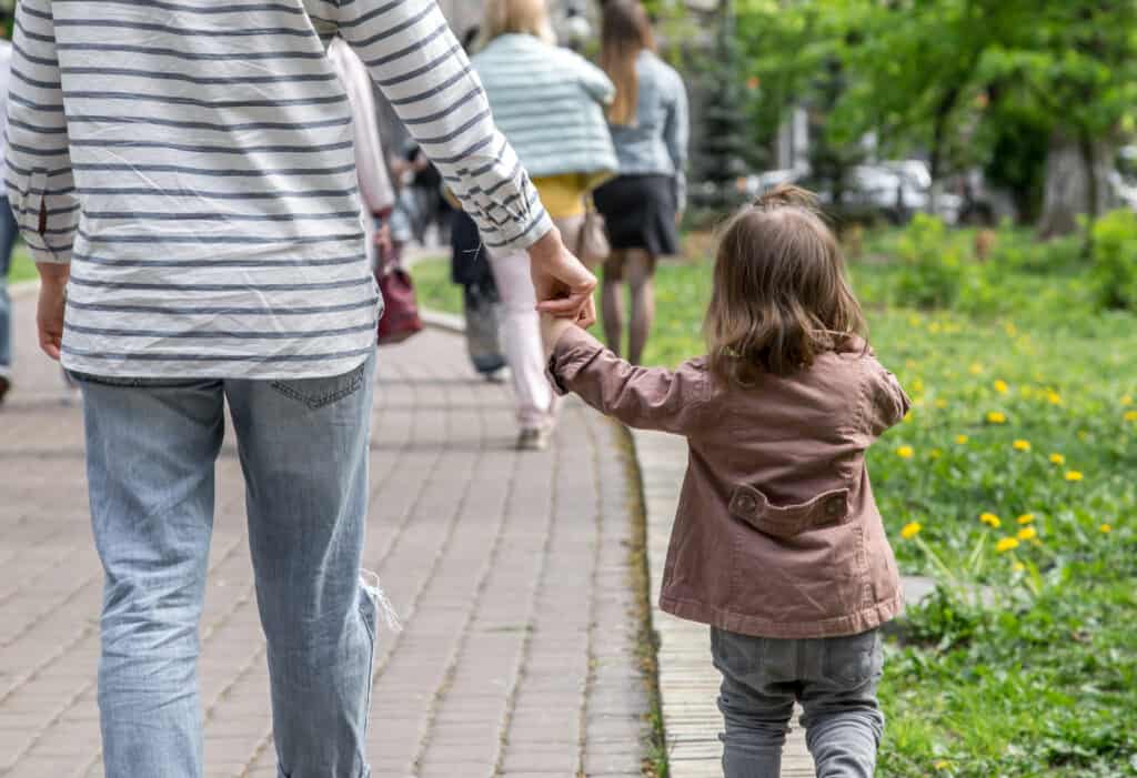 a little girl goes hand in hand with mom in the Park ,the concept of children