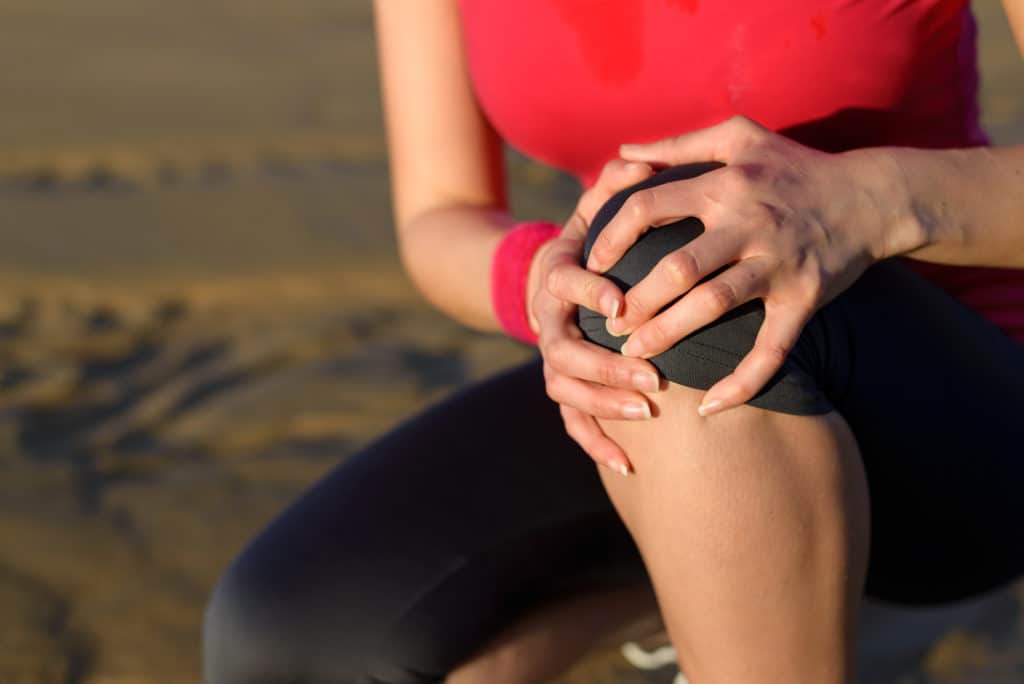 woman with knee pain caused by exercise
