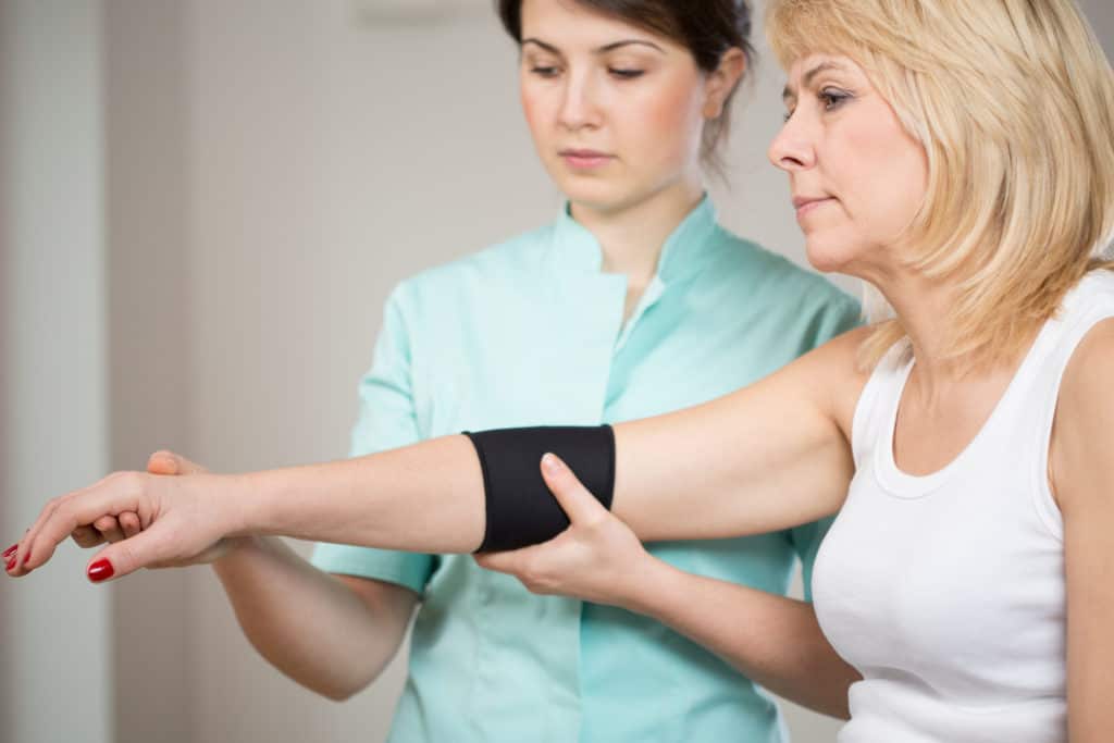 Woman receiving physical therapy for an elbow injury 
