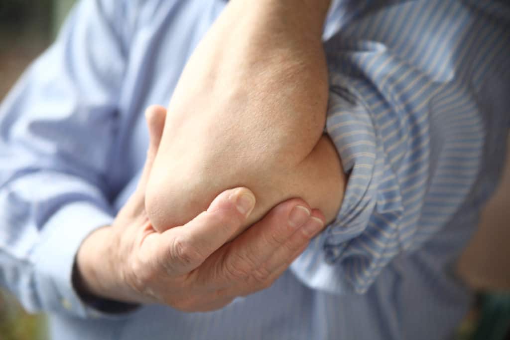 Man holding his elbow in pain 