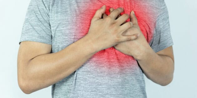 a person holding his chest with pulled muscle in chest