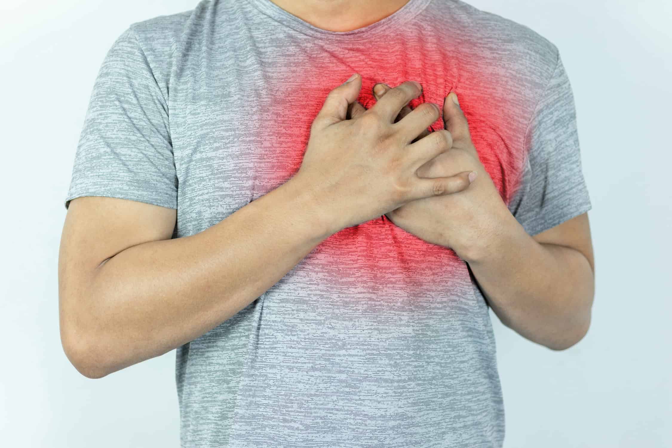 a person holding his chest with pulled muscle in chest