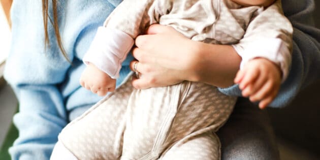 mom holding baby with Postpartum joint pain