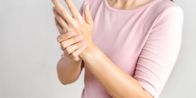 young woman struggling with arthritis on her hands