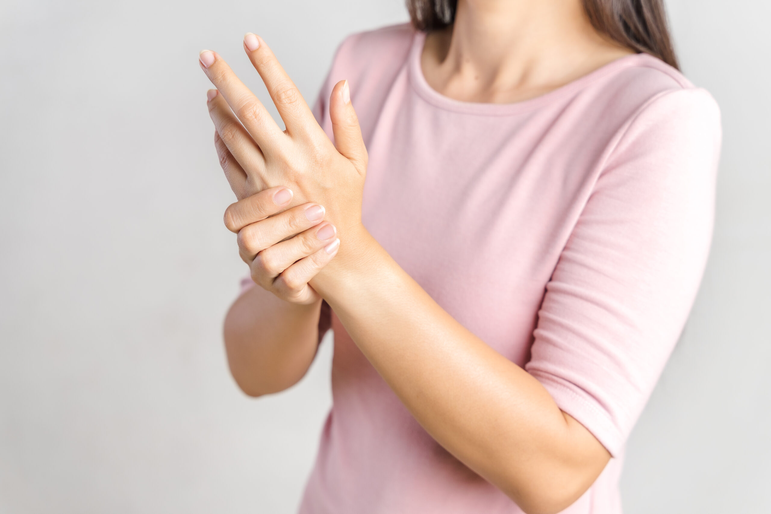 young woman struggling with arthritis on her hands