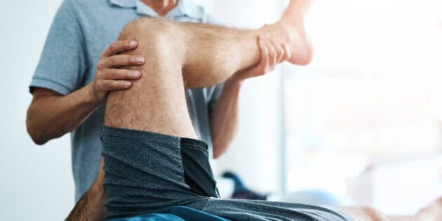 Physical therapist working with older adult patient on knee prehab exercises at Intecore Physical Therapy in Bremerton Washington