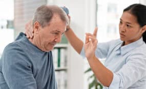 Physical therapist treating patient shoulder rotator cuff rehabilitation at Intecore Physical Therapy in Bremerton Washington