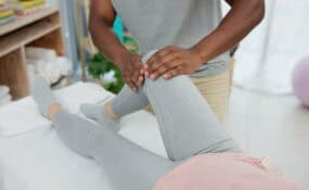 Physical therapist helping patient with knee replacement recovery exercises at Intecore Physical Therapy in Bremerton Washington