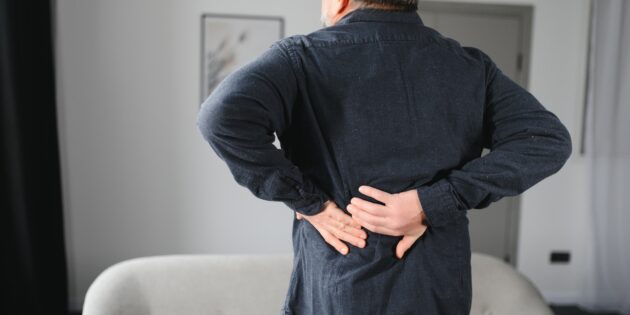 senior man with back pain on a cold morning