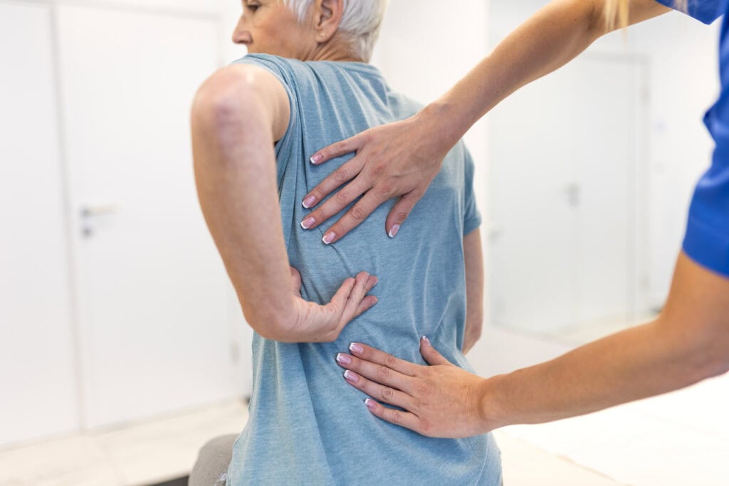 Physical therapist guiding patient through spinal fusion recovery exercises at Intecore Physical Therapy in Bremerton Washington