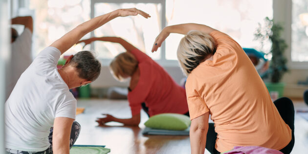 Group of seniors doing yoga for a pain-free 2025