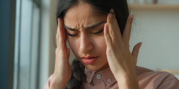 woman struggling with headaches
