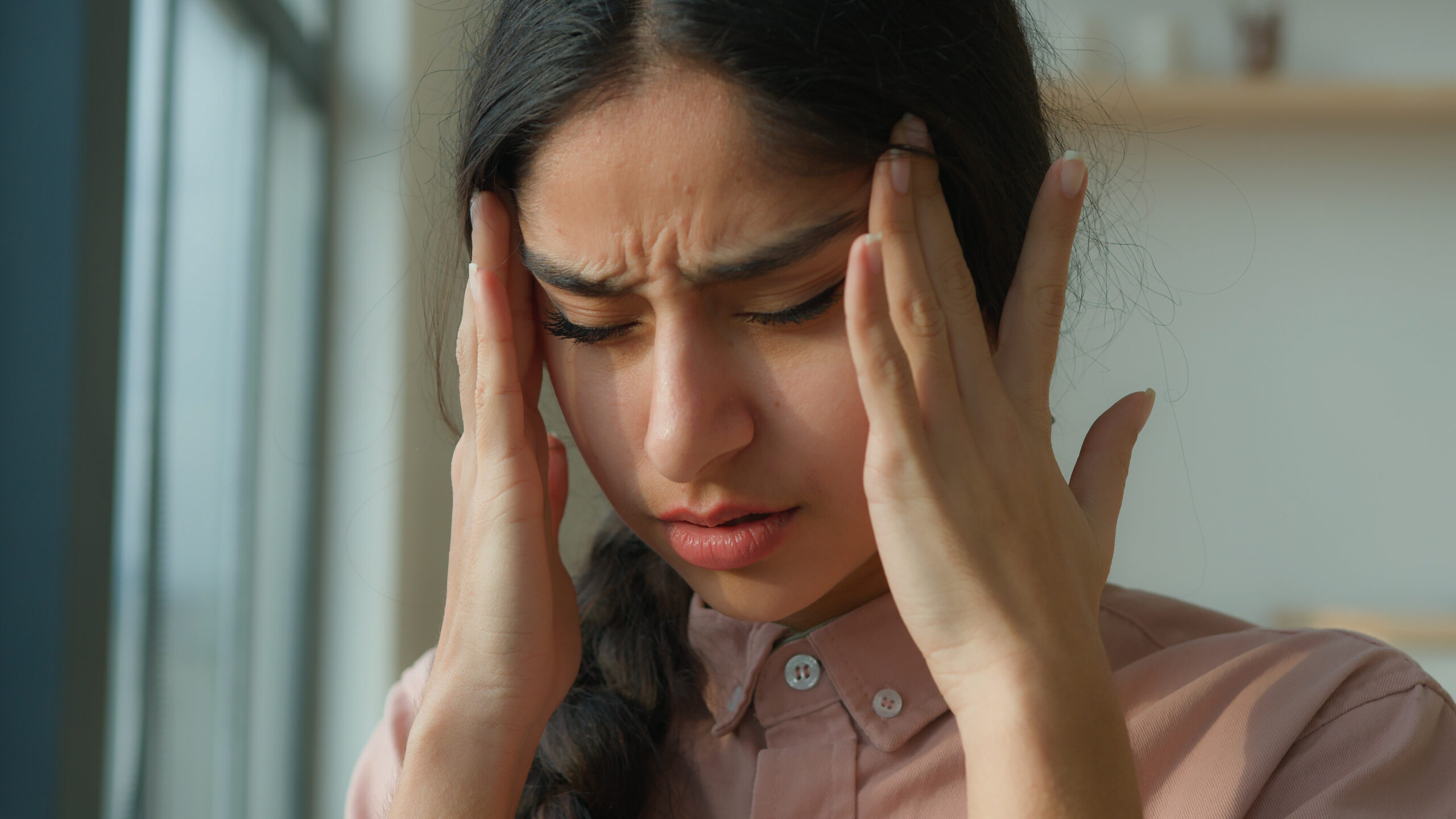 woman struggling with headaches