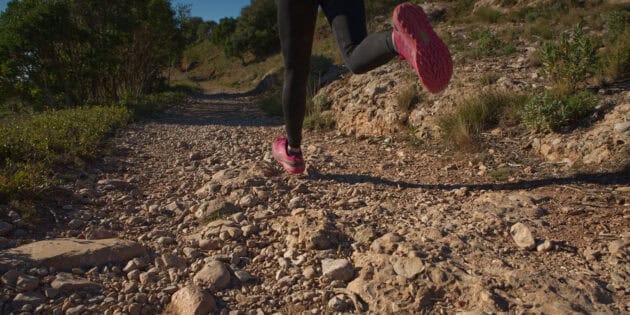 woman trail running with pink shoes