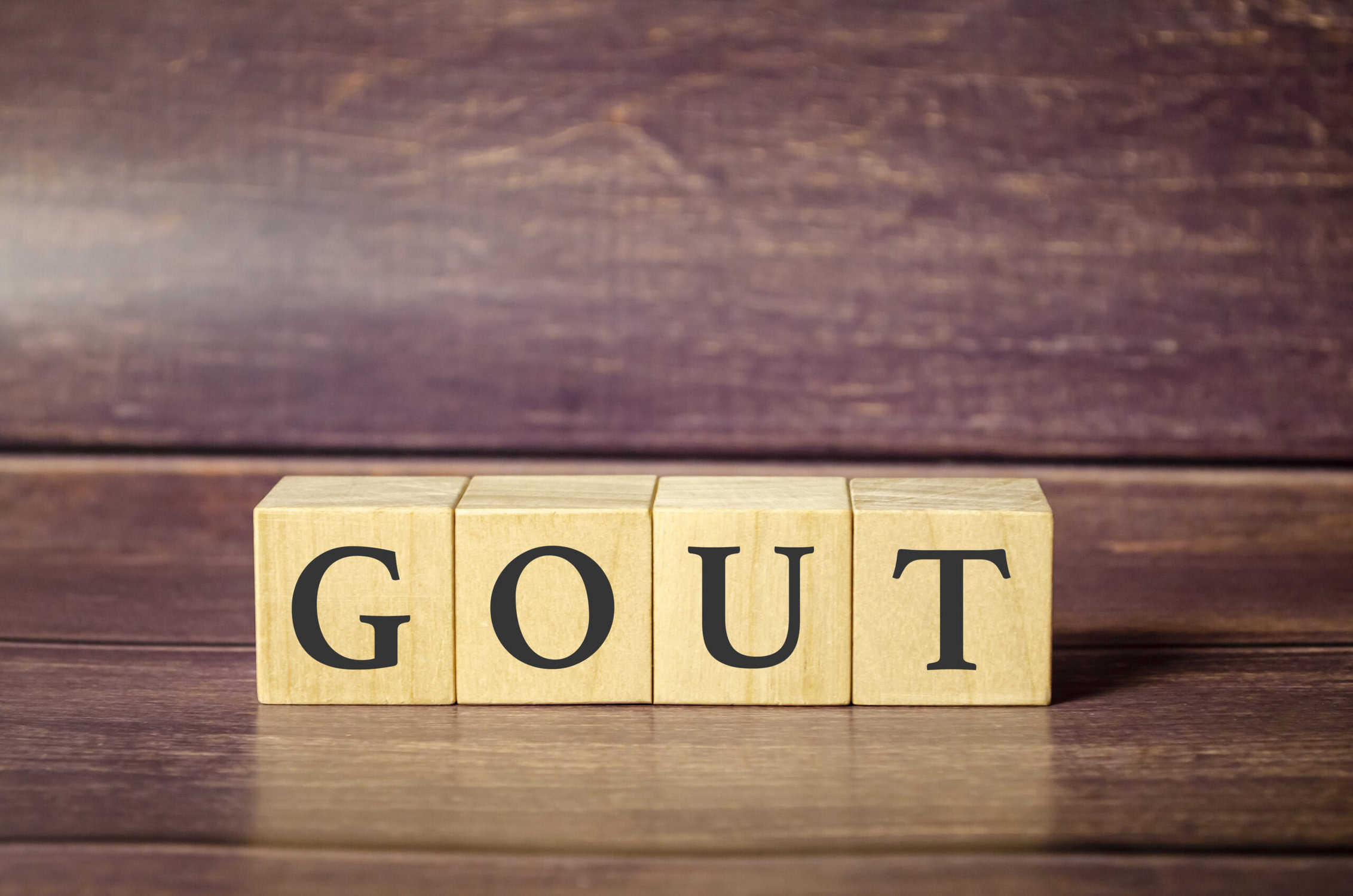 a wooden blocks with black letters on for gout pain
